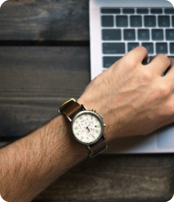 Male Wrist with a watch on a Keyboard
